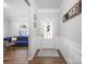 Bright foyer with a glass-paneled front door, decorative wall trim, and hardwood flooring at 117 Autumn Mist Rd, Statesville, NC 28677