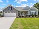 Charming single-story home with stone accents, a two-car garage, and beautifully landscaped front yard at 117 Autumn Mist Rd, Statesville, NC 28677