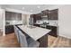 A spacious kitchen featuring an island with barstool seating, granite countertops, and stainless appliances at 117 Autumn Mist Rd, Statesville, NC 28677