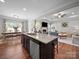 Open kitchen featuring a granite-topped island, stainless steel appliances, and an adjacent dining area and living room at 117 Autumn Mist Rd, Statesville, NC 28677