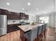 Modern kitchen with stainless steel appliances, a granite-topped island, and dark wood cabinetry at 117 Autumn Mist Rd, Statesville, NC 28677