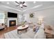 Cozy living room with a fireplace, plush sofas, and plenty of natural light creating a warm atmosphere at 117 Autumn Mist Rd, Statesville, NC 28677
