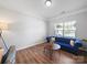 Cozy living room featuring a plush blue sofa, hardwood floors, and ample natural light at 117 Autumn Mist Rd, Statesville, NC 28677