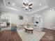 Bright living room with hardwood floors, comfortable seating, and an open layout to the bedroom and kitchen at 117 Autumn Mist Rd, Statesville, NC 28677