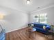 Cozy living room featuring a plush blue sofa, hardwood floors, and ample natural light at 117 Autumn Mist Rd, Statesville, NC 28677
