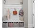 Well-organized mudroom with bench seating, storage baskets, and hooks for coats and bags at 117 Autumn Mist Rd, Statesville, NC 28677