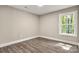 This small bedroom showcases hardwood floors and natural light from a large window at 1234 Goodnight Ln, Kannapolis, NC 28081