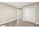 Bright bedroom features neutral paint, gray wood-look flooring and a closet with bi-fold doors at 1234 Goodnight Ln, Kannapolis, NC 28081