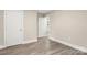 Hallway leads to other rooms, boasting new hardwood floors and fresh neutral paint at 1234 Goodnight Ln, Kannapolis, NC 28081