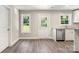 Well-lit kitchen with stainless steel dishwasher, white cabinets and granite counters at 1234 Goodnight Ln, Kannapolis, NC 28081