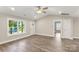 Open living area showcases new flooring, a ceiling fan, and natural light through the window at 1234 Goodnight Ln, Kannapolis, NC 28081