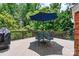Back deck with a round metal table and four matching chairs underneath a large blue umbrella at 1399 Verdict Ridge Dr, Denver, NC 28037
