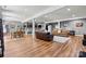 Entertainer's basement featuring multiple seating areas, a bar, dinette, and hardwood floors at 1399 Verdict Ridge Dr, Denver, NC 28037