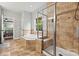 Tiled bathroom with a glass enclosed shower, soaking tub and view of backyard at 1399 Verdict Ridge Dr, Denver, NC 28037