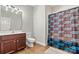 Neutral bathroom featuring a single sink vanity, tiled floors, standard toilet, and Carolina Panthers-themed shower curtain at 1399 Verdict Ridge Dr, Denver, NC 28037