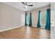Bedroom featuring hardwood floors and bright teal curtains at 1399 Verdict Ridge Dr, Denver, NC 28037