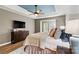 Comfortable bedroom featuring a tray ceiling, ceiling fan, and a TV for entertainment at 1399 Verdict Ridge Dr, Denver, NC 28037