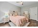 Comfortable bedroom featuring hardwood floors, a ceiling fan, natural light, rustic furniture and walk-in closet at 1399 Verdict Ridge Dr, Denver, NC 28037