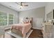 Cozy bedroom featuring hardwood floors, a ceiling fan, natural light, rustic furniture and a walk-in closet at 1399 Verdict Ridge Dr, Denver, NC 28037