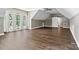 Bright bonus room with hardwood floors, a ceiling fan, barn door and three large windows providing natural light at 1399 Verdict Ridge Dr, Denver, NC 28037