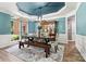 Dining room with a decorative ceiling, blue walls, and a wooden table with chairs and a bench at 1399 Verdict Ridge Dr, Denver, NC 28037
