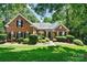 Attractive brick house featuring a well-maintained lawn and meticulously arranged landscaping at 1399 Verdict Ridge Dr, Denver, NC 28037