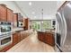 Spacious kitchen features wooden cabinetry, stainless steel appliances, and a center island with bar seating at 1399 Verdict Ridge Dr, Denver, NC 28037