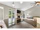 Living room with a stone fireplace, mantel, built-in shelving, and large windows offering serene views at 1399 Verdict Ridge Dr, Denver, NC 28037