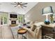 Bright and inviting living room with a fireplace, TV, large windows, and comfortable seating at 1399 Verdict Ridge Dr, Denver, NC 28037