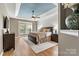 Spacious main bedroom featuring hardwood floors, fan, and blue ceiling detail at 1399 Verdict Ridge Dr, Denver, NC 28037