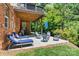 Outdoor patio area with an Ole Miss flag, a grill, lounge chairs, and lush green backyard at 1399 Verdict Ridge Dr, Denver, NC 28037