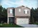 Two-story home featuring gray siding, brick accents, well-manicured lawn, and an attached two-car garage at 1402 31St Ne St, Conover, NC 28613
