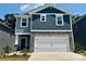 Two-story home with blue siding, stone accents, and a two-car garage, set against a blue sky at 1418 31St Ne St, Conover, NC 28613