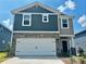 Charming two-story home featuring a two-car garage, stone accents, and a welcoming front porch at 1431 31St Ne St, Conover, NC 28613