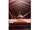 Exposed attic with wooden beams, insulation, and peek of natural light at 1901 Taylor Dr, Gastonia, NC 28052