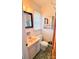 Cozy bathroom features a toilet, sink with vanity, mirror, and window with natural light at 1901 Taylor Dr, Gastonia, NC 28052
