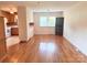 Bright dining room with hardwood floors, chandelier, and view into the kitchen at 1901 Taylor Dr, Gastonia, NC 28052