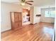 Dining room with hardwood floors, view into kitchen, and decorative cabinet at 1901 Taylor Dr, Gastonia, NC 28052