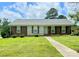 Charming single-story home featuring a well-maintained lawn, brick accents, and a welcoming front entrance at 1901 Taylor Dr, Gastonia, NC 28052