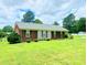 Attractive single-story home featuring a well-manicured lawn and a brick facade with a stone accent at 1901 Taylor Dr, Gastonia, NC 28052
