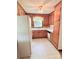 Functional kitchen with wooden cabinets, a window over the sink, and appliances at 1901 Taylor Dr, Gastonia, NC 28052