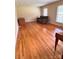Living room with hardwood floors, natural light from the window, and a large couch at 1901 Taylor Dr, Gastonia, NC 28052