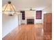 Bright living room featuring hardwood floors, a fireplace, and built-in shelving units at 1901 Taylor Dr, Gastonia, NC 28052