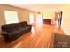 Spacious living room featuring hardwood floors, a window, and a large couch at 1901 Taylor Dr, Gastonia, NC 28052