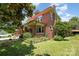 Side view of a well-maintained two-story brick home with manicured lawn and mature trees at 206 Mitchell Ave, Salisbury, NC 28144