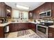 View of the kitchen with stainless appliances and white countertops, dark wood cabinets at 206 Mitchell Ave, Salisbury, NC 28144