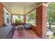 Relaxing covered porch with comfortable seating and classic brick columns at 206 Mitchell Ave, Salisbury, NC 28144