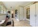 Bright sunroom area with tile flooring and closet and transition to in-house laundry setup at 206 Mitchell Ave, Salisbury, NC 28144