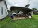 Carport next to the house with assorted items stored inside at 211 Oak Dr, Shelby, NC 28150