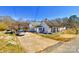 Exterior view of a traditional home with a long driveway and covered parking at 211 Oak Dr, Shelby, NC 28150